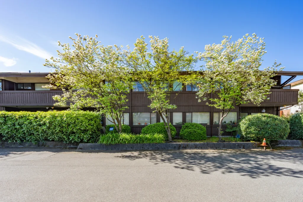 Cedar Court Apartments landscaped front facade with flowering cherry trees