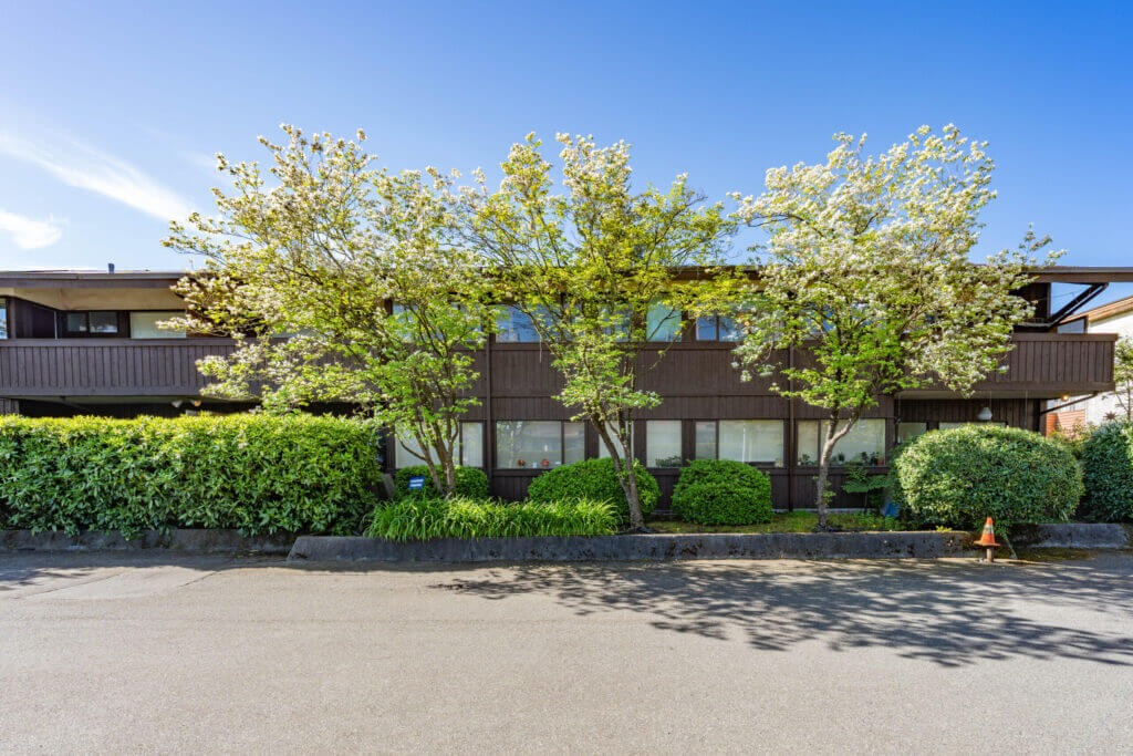 Cedar Court Apartments landscaped front facade with flowering cherry trees