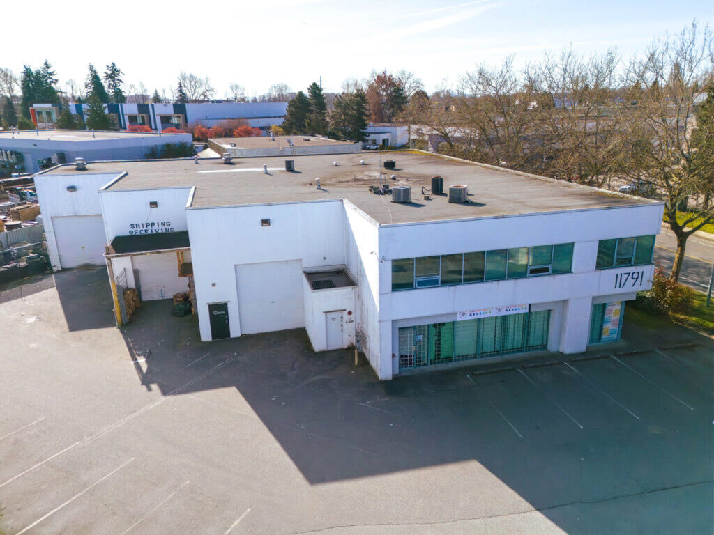11791 Machrina Way elevated view showing rooftop, parking lot, and loading area