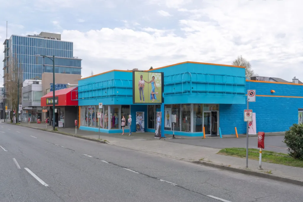 1862 West Broadway street-level exterior with blue facade and retail storefronts