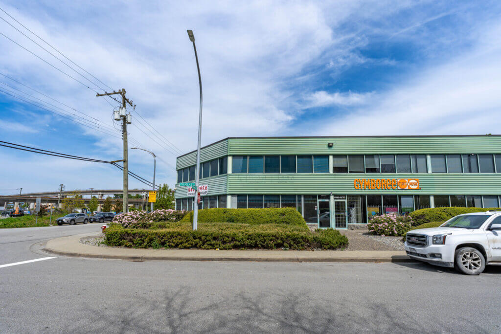 8771 Douglas Street south facade with tenant signage and landscaping