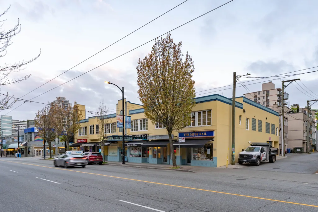 903 Denman Street corner exterior showing ground-floor retail storefronts on Denman Street