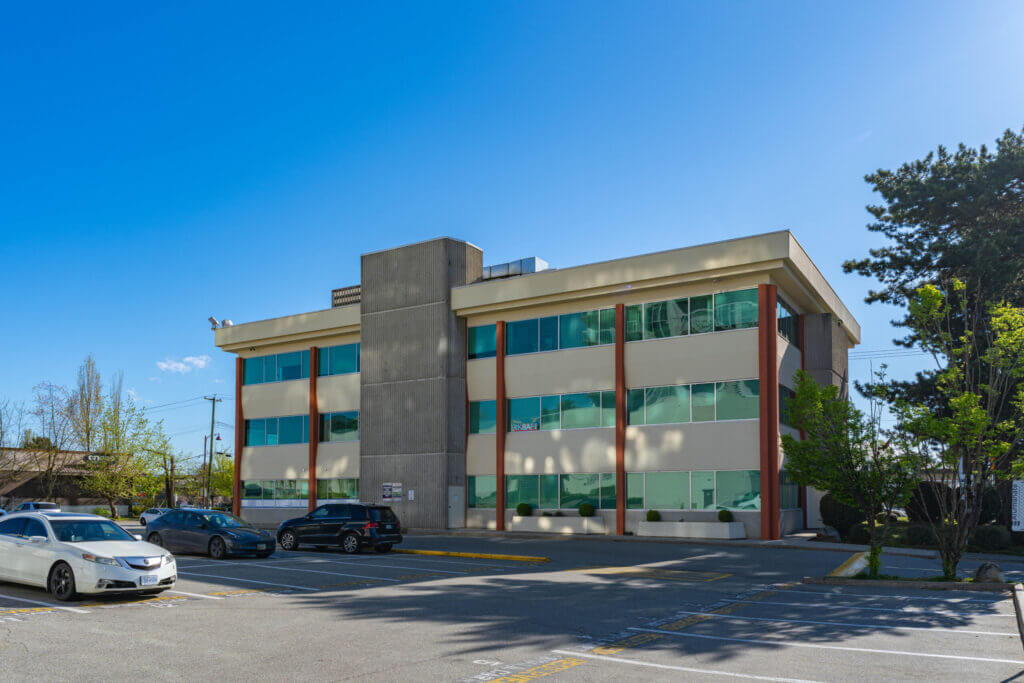 Delta Professional Building rear exterior with surface parking in North Delta