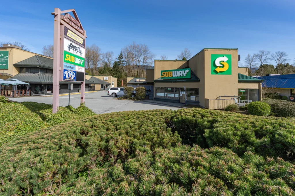 Eagle Ridge Plaza pylon directory sign and storefronts from Barnet Highway
