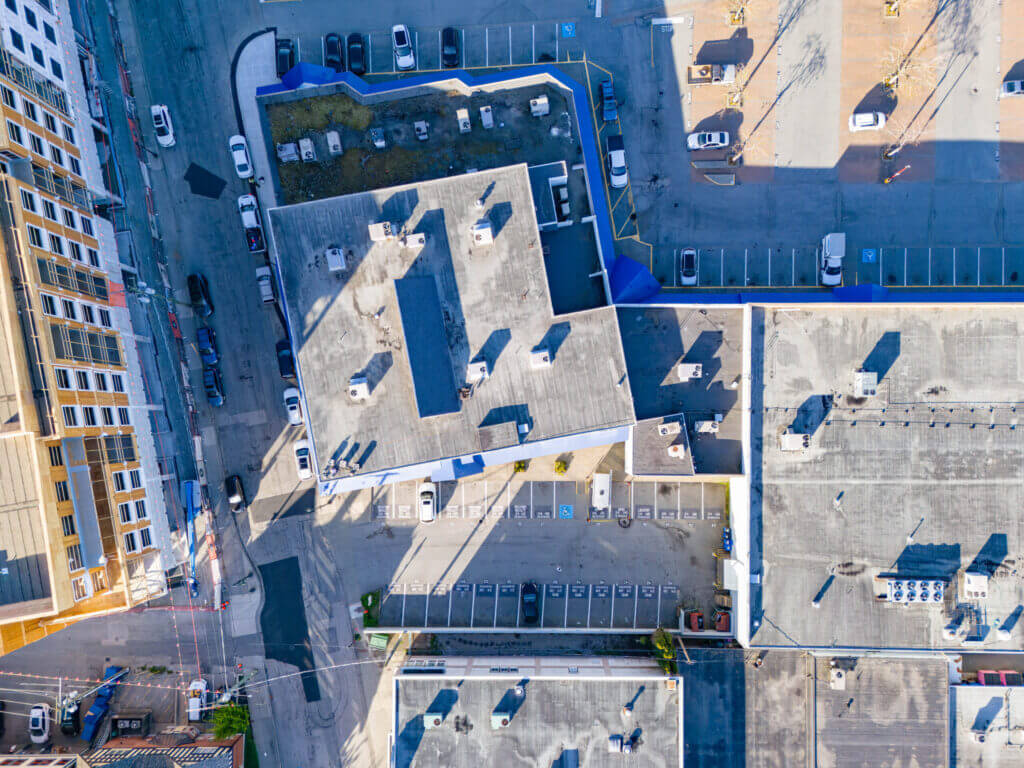 Top-down aerial view of Ladner Harbour Centre rooftop and surface parking lot