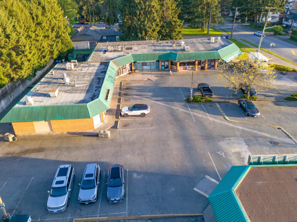 Nordel Place aerial view of L-shaped retail building and surface parking in North Delta