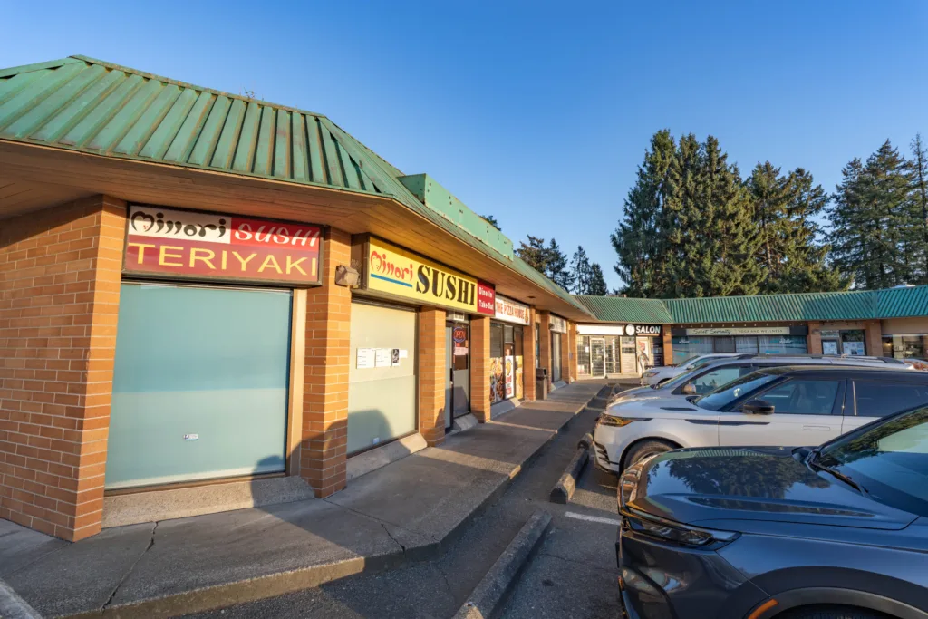 Nordel Place storefront close-up showing retail tenants and green awning on 112 Street