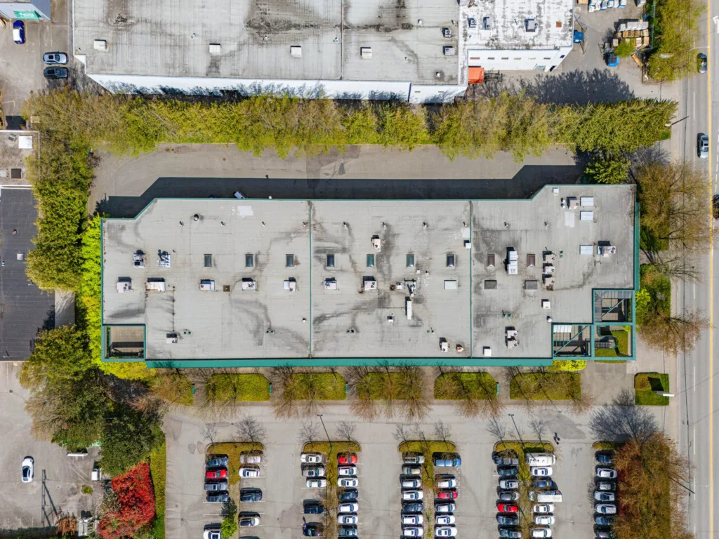 Omnia Centre overhead view showing full building footprint and surface parking lot
