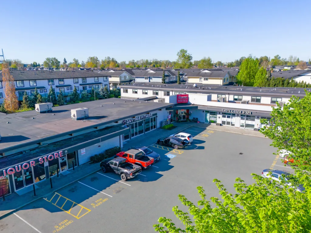 Queens Plaza retail storefronts and surface parking on Ewen Avenue in Queensborough