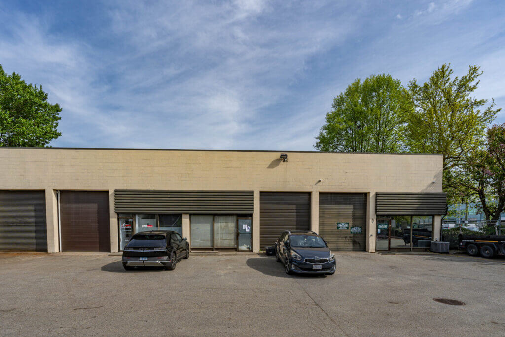 Valmont Building front facade with multiple warehouse bays and roll-up doors at 1301-1311 Valmont Way