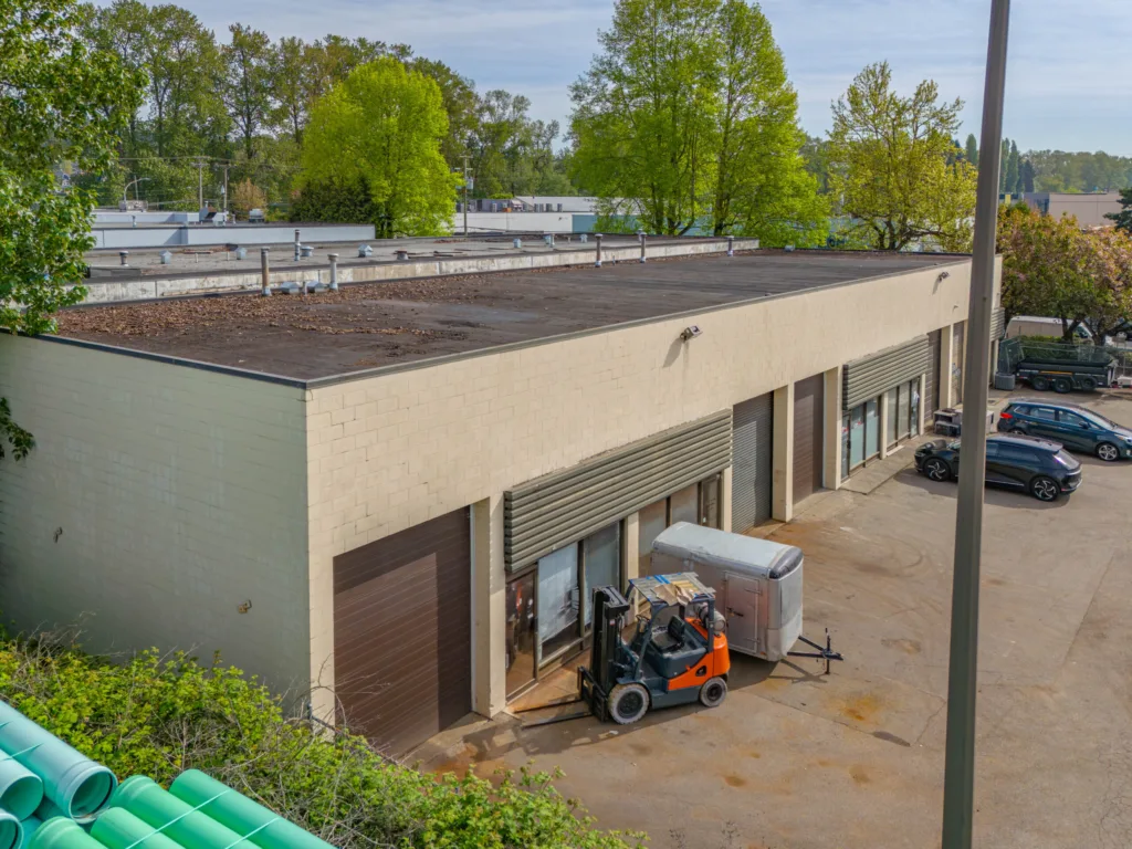 Valmont Building aerial view of warehouse units with roll-up doors and forklift at 1301-1311 Valmont Way