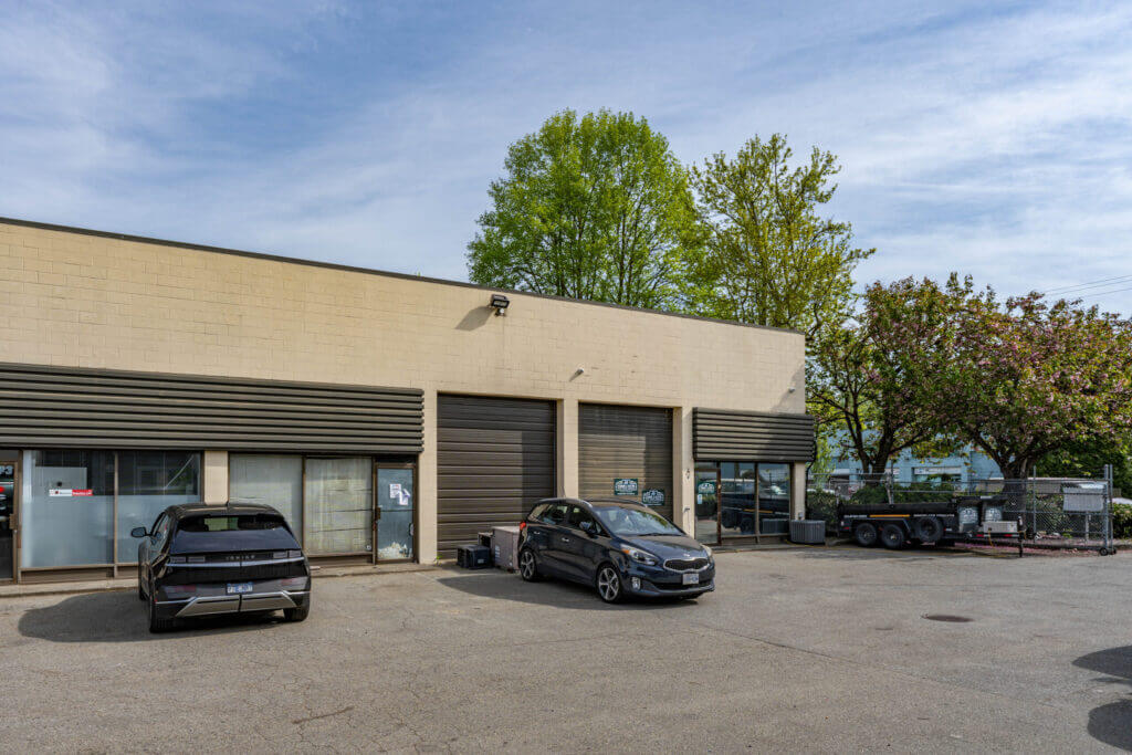 Valmont Building street-level exterior showing roll-up doors and surface parking in Richmond