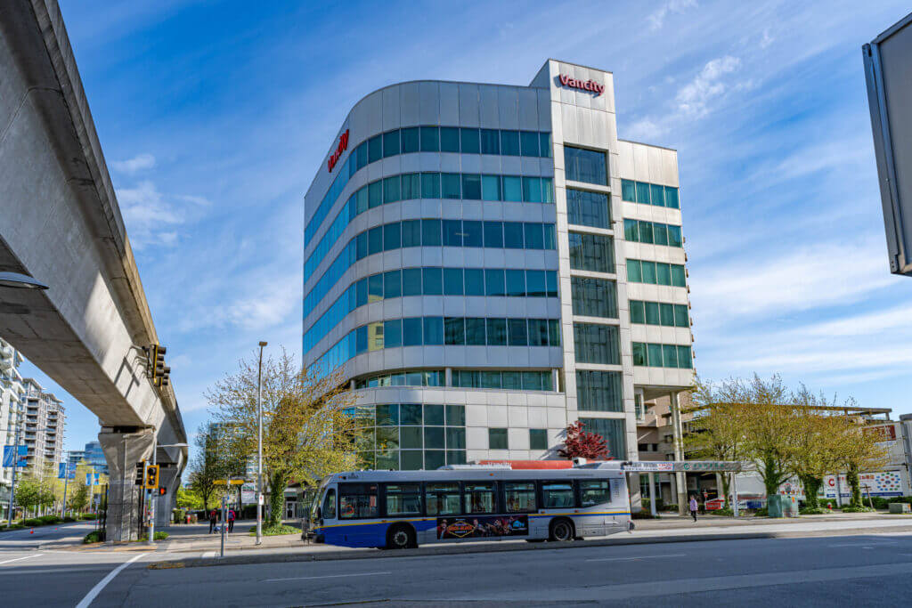 Vancity Tower street-level view with transit bus and Canada Line guideway on No. 3 Road