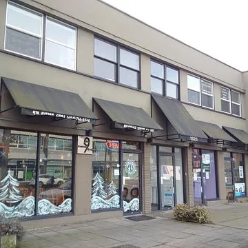 1826-1828 West Broadway building exterior with street-level retail and awnings