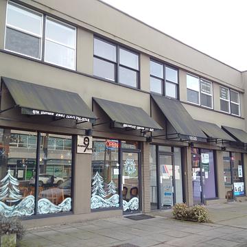1826-1828 West Broadway building exterior with street-level retail and awnings
