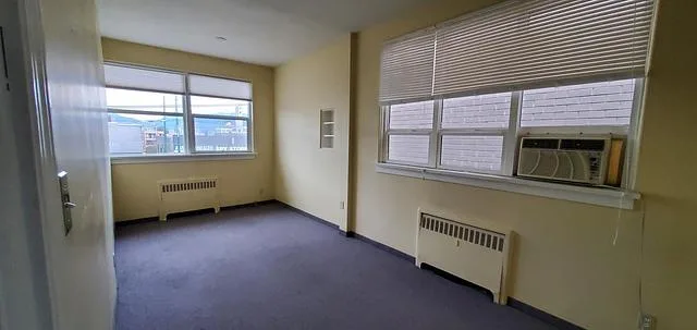 1826-1828 West Broadway Unit 201 office room with windows and radiator heating