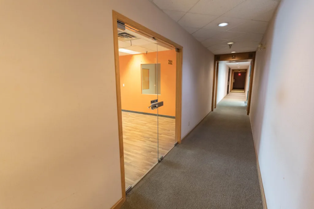 1212 West Broadway Unit 200 corridor entrance with glass door