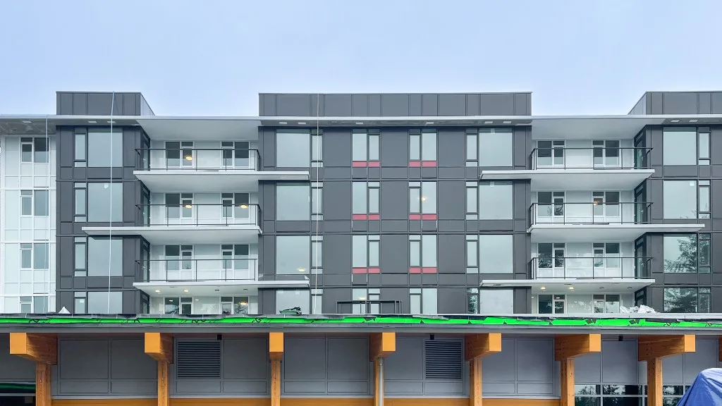 Lelem Village University Blvd Building exterior facade with balconies at 5380 University Blvd, Vancouver