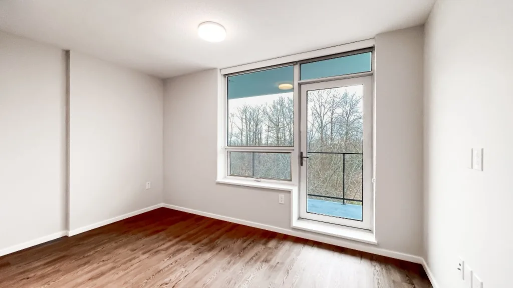 Lelem Village University Blvd living room with balcony door and park view