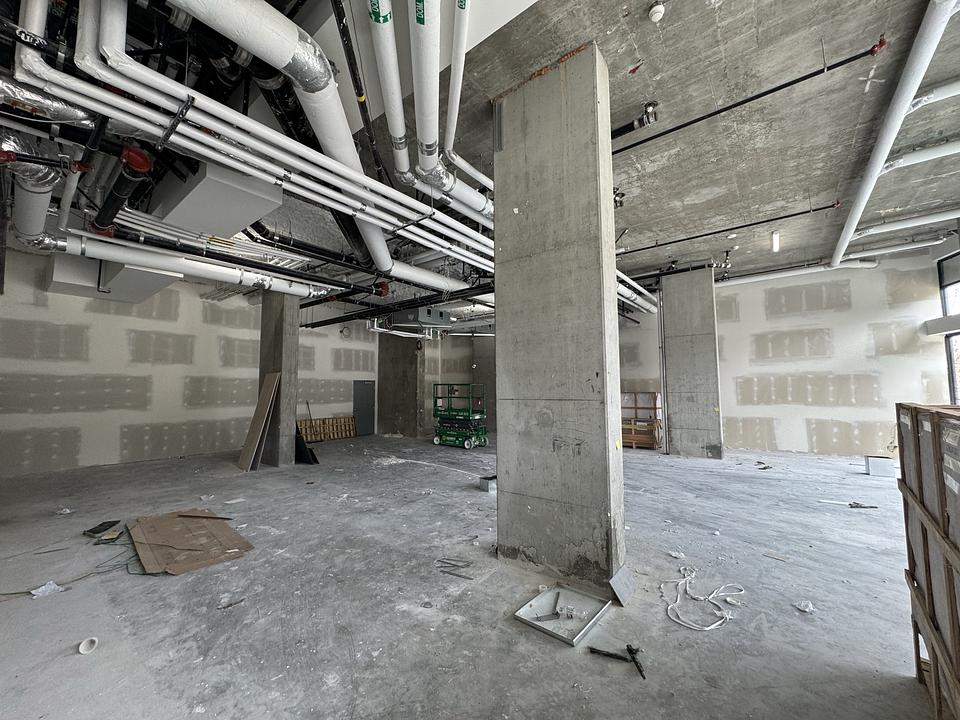 One Park Richmond Unit 150 rear interior with high ceilings and exposed utility piping