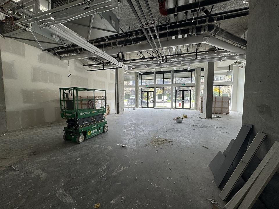 One Park Richmond Unit 150 open interior shell with high ceilings and storefront windows