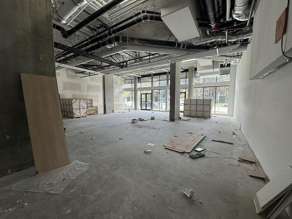 One Park Richmond Unit 150 interior space with exposed mechanical systems and concrete columns