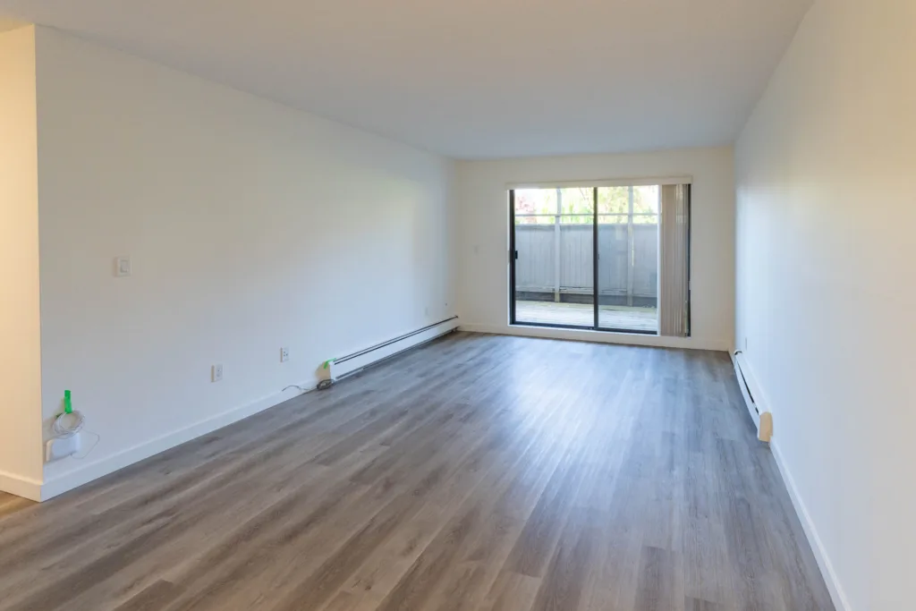Open living area with hardwood-style floors in Unit 201 at Charles Manor Charles St