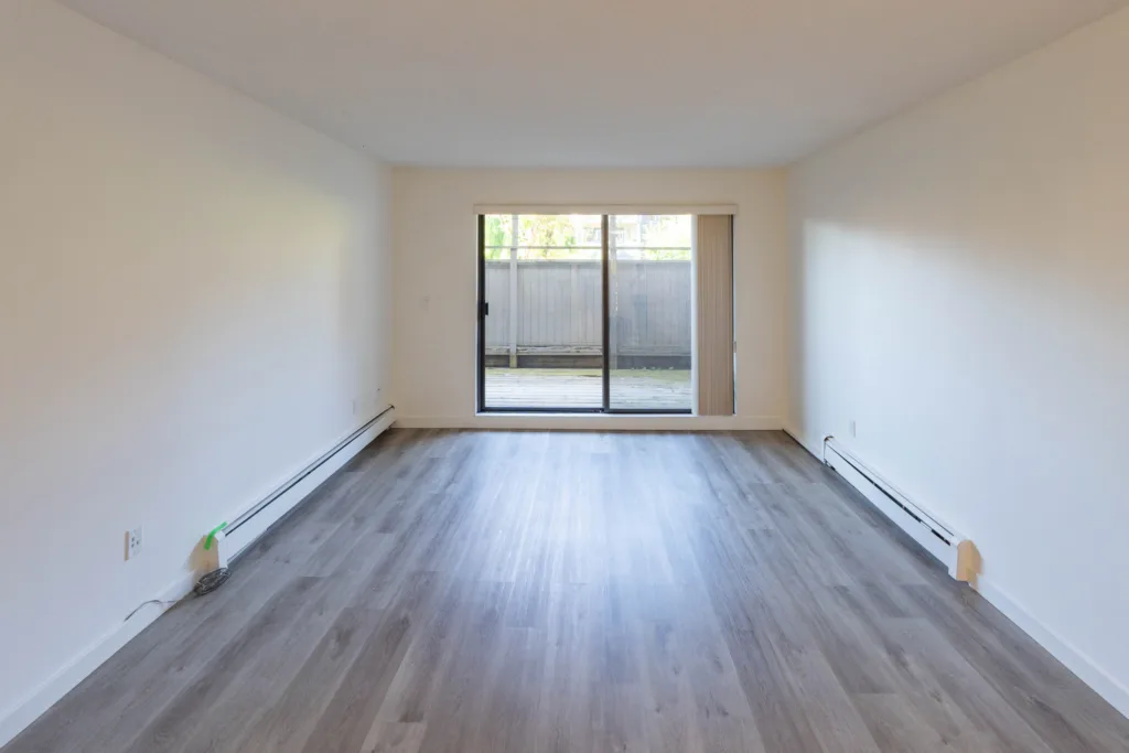 Living room with sliding patio door in Unit 201 at 1556 Charles St