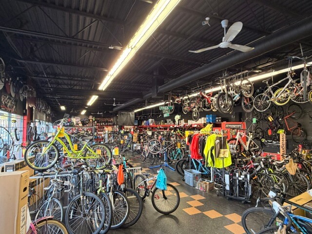 Spacious retail interior with ceiling fans and bicycle inventory at 8400-8460 Alexandra Road Unit 135