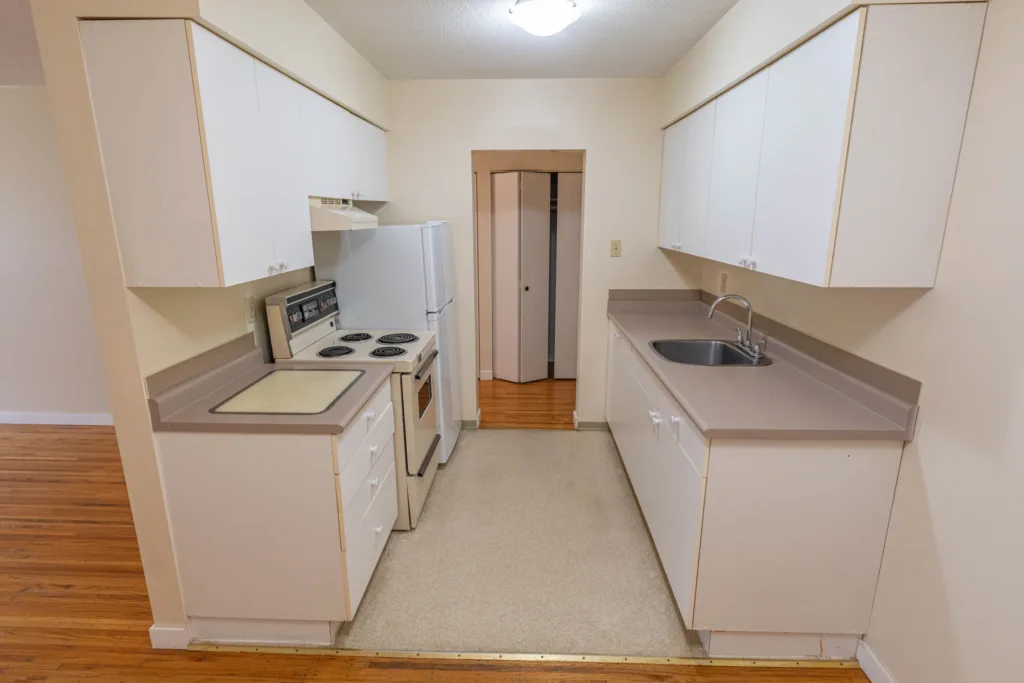 Galley kitchen with fridge and countertops at 7175 Pandora Street Unit 22