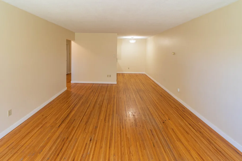 Spacious room with hardwood floors and hallway at 7175 Pandora Street Unit 22