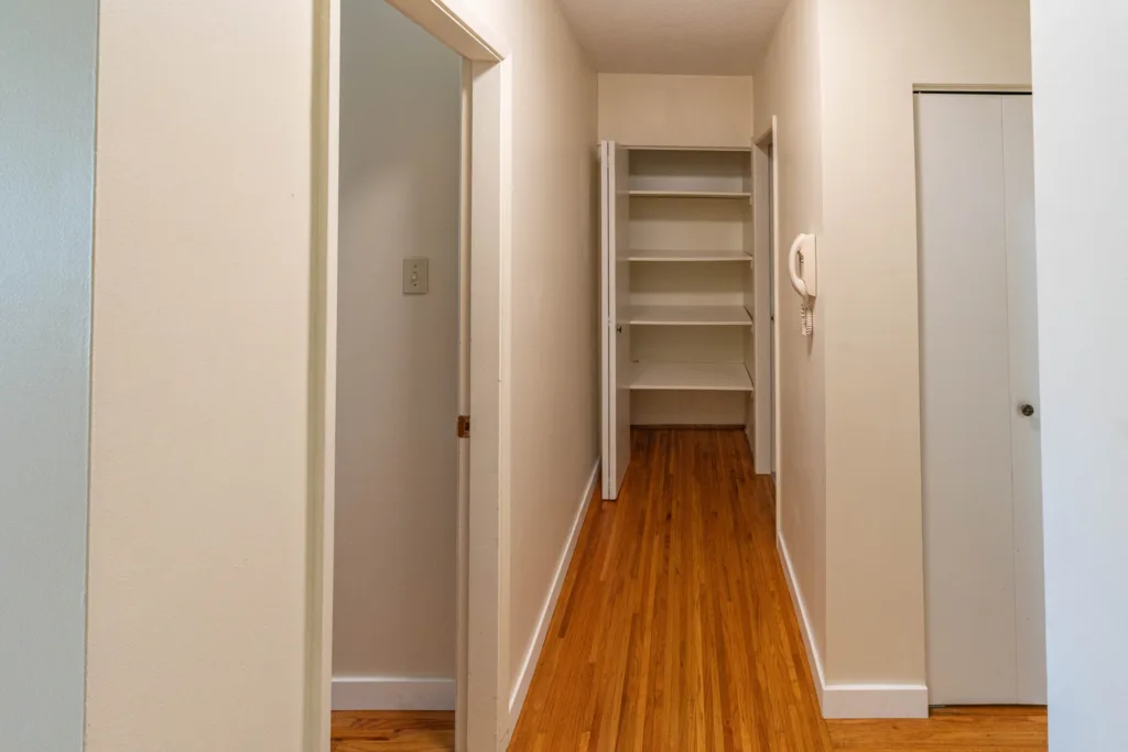 Hallway with storage closet and hardwood floors at 7175 Pandora Street Unit 22