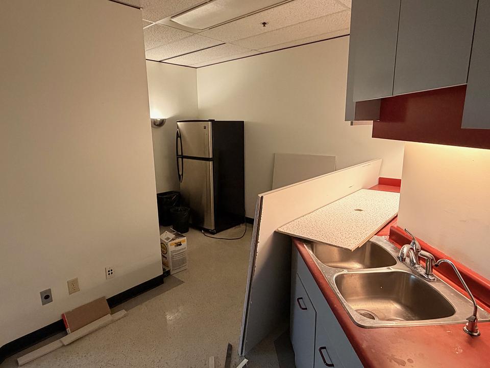 Kitchenette with sink and fridge in office Unit N412 at 5811 Cooney Road