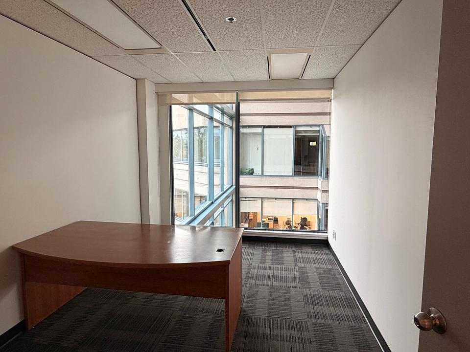Private office with desk and atrium view at 5811 Cooney Road Unit N412
