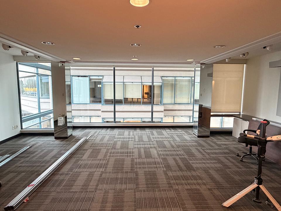 Open work area with atrium windows at 5811 Cooney Road Unit N412