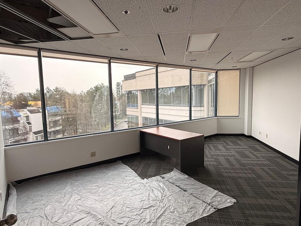 Corner office with large windows at 5811 Cooney Road Unit N412