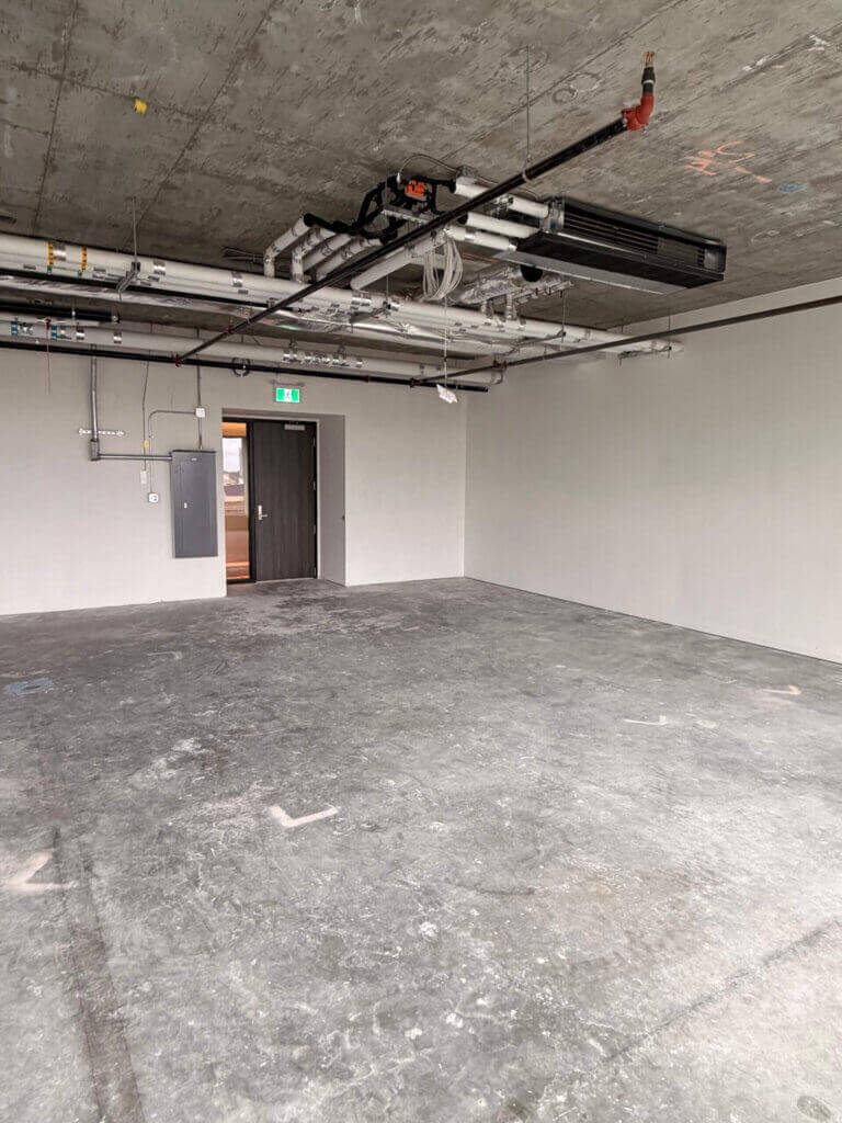5599 No. 3 Road Unit 425 open-plan office interior with exposed concrete ceiling and HVAC
