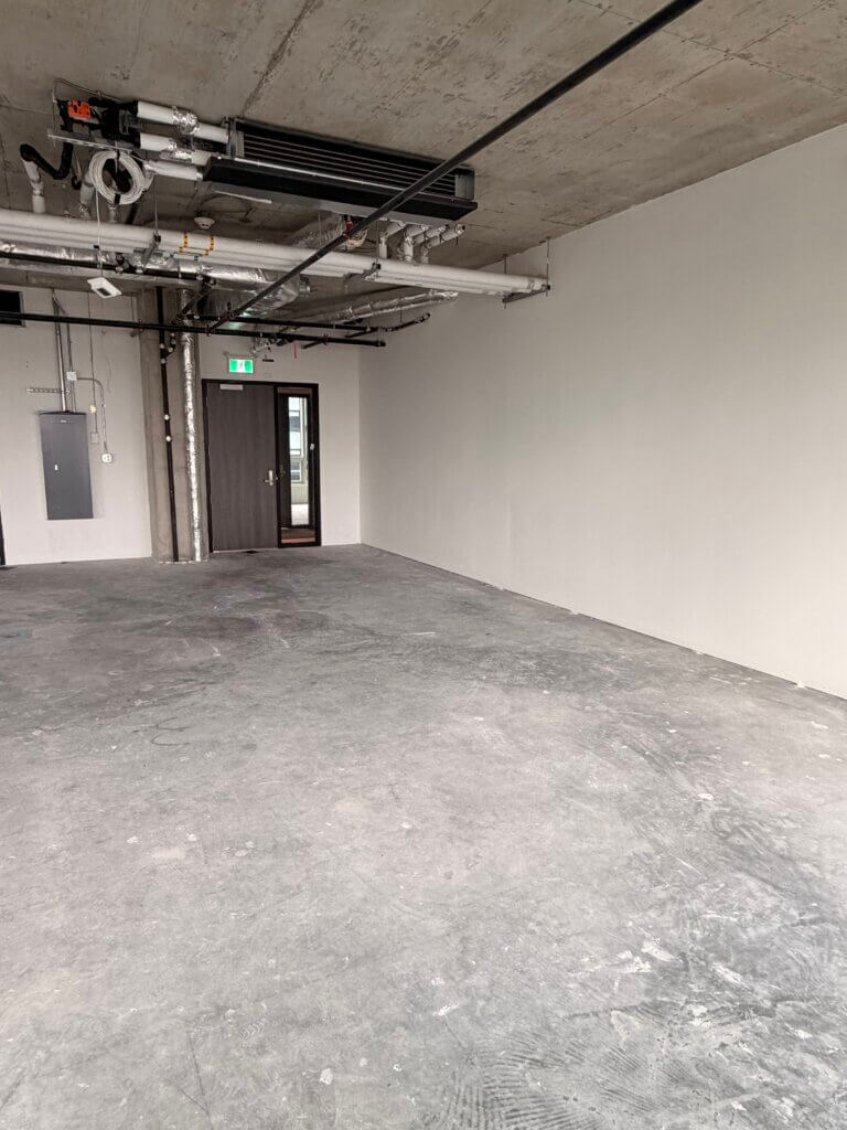 Office unit entry door and exposed concrete ceiling at 5599 No. 3 Road Unit 715