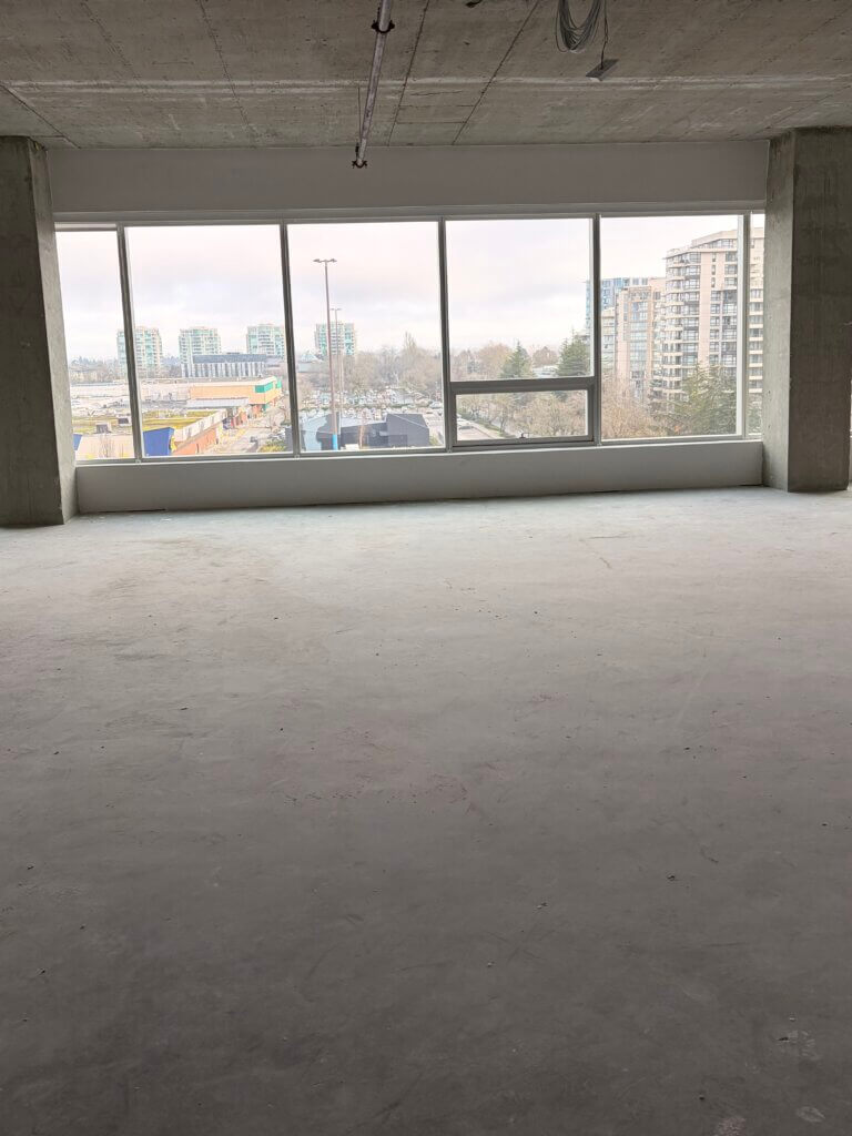 Interior of office Unit 720 at 5599 No. 3 Road with east-facing windows and city view
