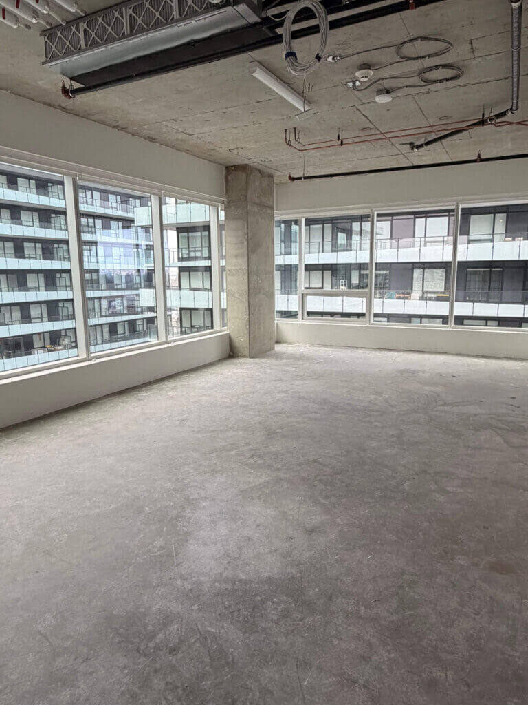 Corner office interior with floor-to-ceiling windows at 5599 No. 3 Road Unit 805