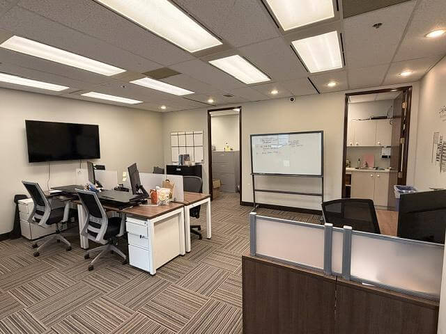 Open work area with desks in office Unit 433 at 5811 Cooney Road